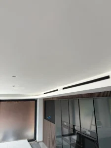 Slimline ceiling air conditioning vents installed in a modern open-plan room